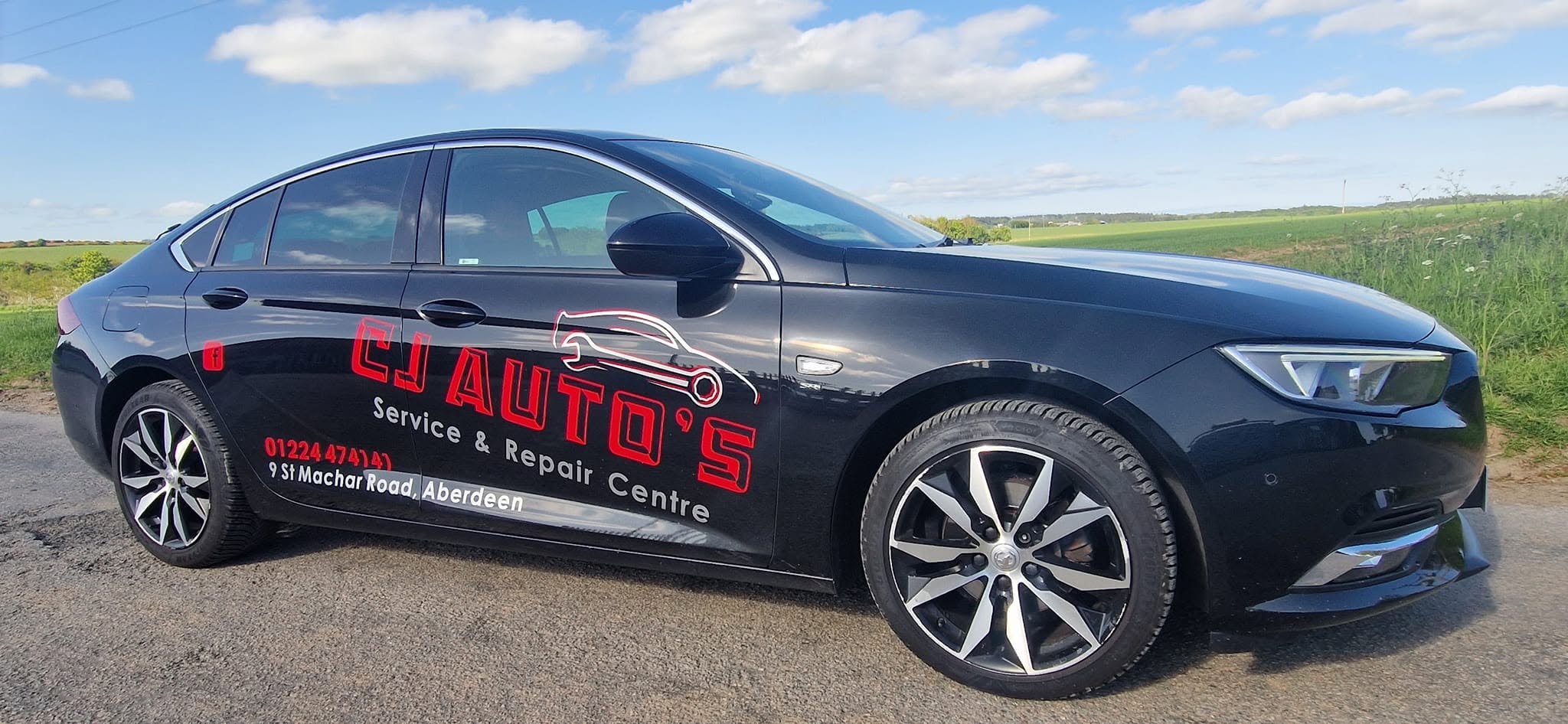 CJ Auto's branded Vauxhall Insignia on a country road
